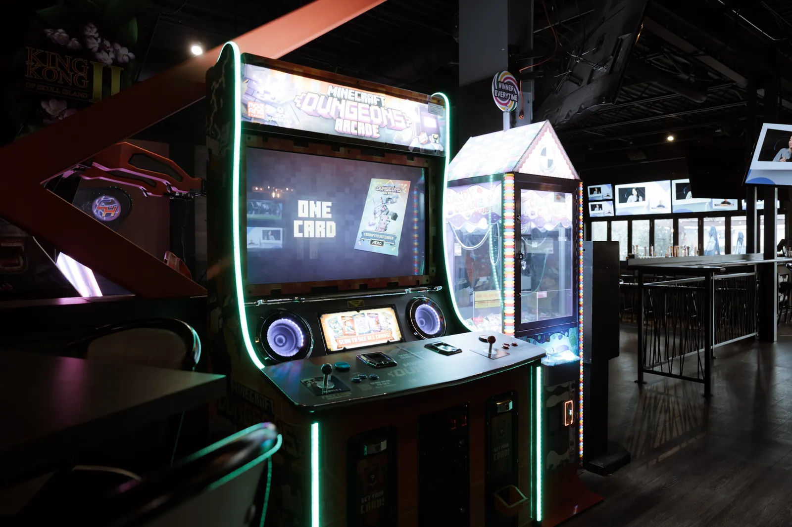 A Minecraft Dungeons arcade cabinet and a candy claw machine lit up
