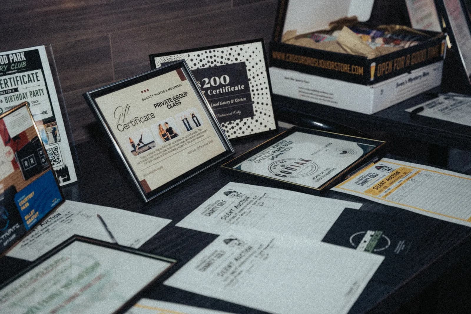 Framed certificates and prizes laid out on the raffle table